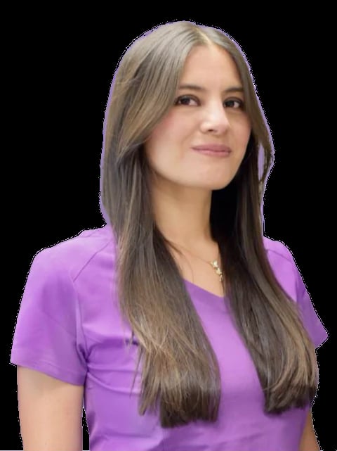 Young woman with long dark hair wearing a purple v-neck shirt